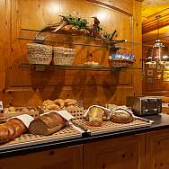 Variety of breads and pastries in a cosy restaurant.