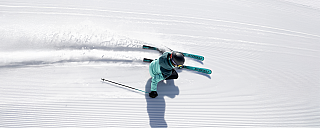 A skier glides over freshly groomed snow.