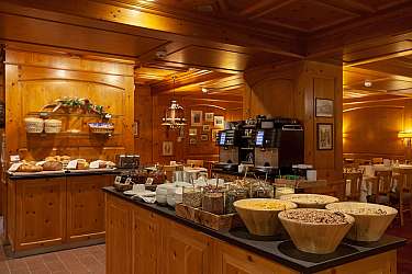Wooden interior with bread and breakfast ingredients on the buffet.