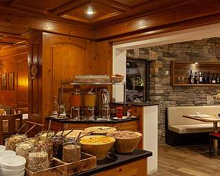 Insight into a restaurant with a buffet and wooden decor.