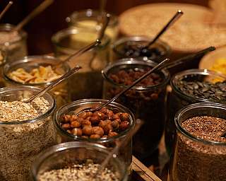 Glasses with various grains and nuts on a table.