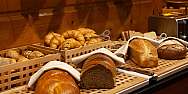 A selection of fresh bread and rolls on a table.