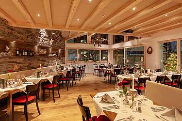 Cozy restaurant with set tables and stylish ambiance.