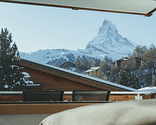 Snow-covered mountains and wooden houses in the winter landscape.