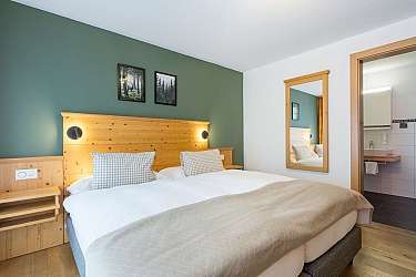 Cozy bedroom with double bed and television.