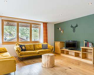 Bright, open-plan kitchen with dining area and cosy furnishings.