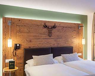 Ein modernes Schlafzimmer mit Holzpaneelen und stilvollen Lampen.